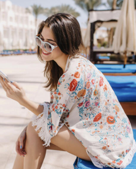 Frosted breeze sunglasses and a loose floral cover-up over a swimsuit.