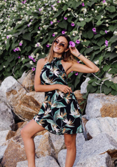 Chestnut-colored sunglasses with a halter-neck style tropical romper.